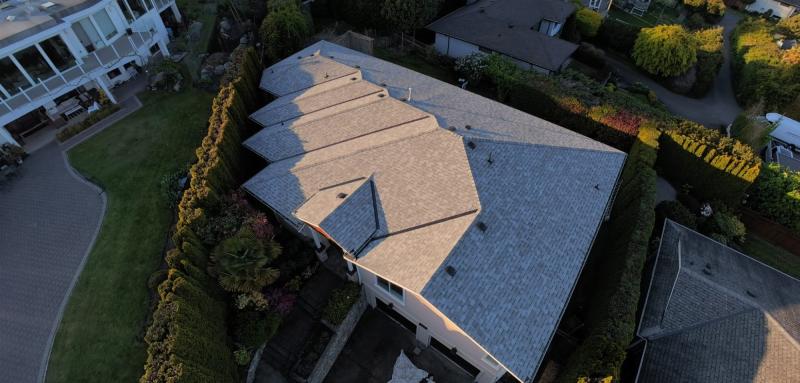 Golden-hour aerial of a completed shingle roof