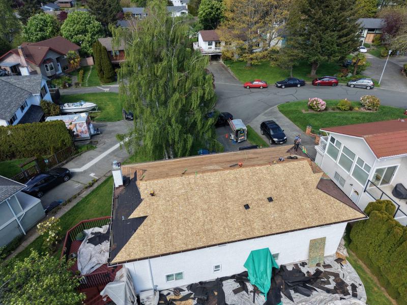 Roof tear-off in progress with exposed decking